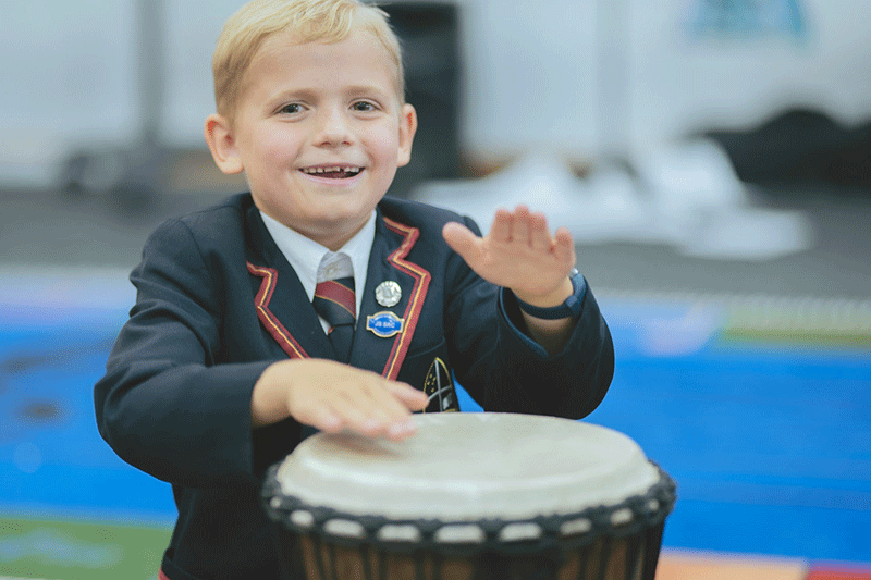 Junior-student-playing-music-instrument-while-smiling.gif